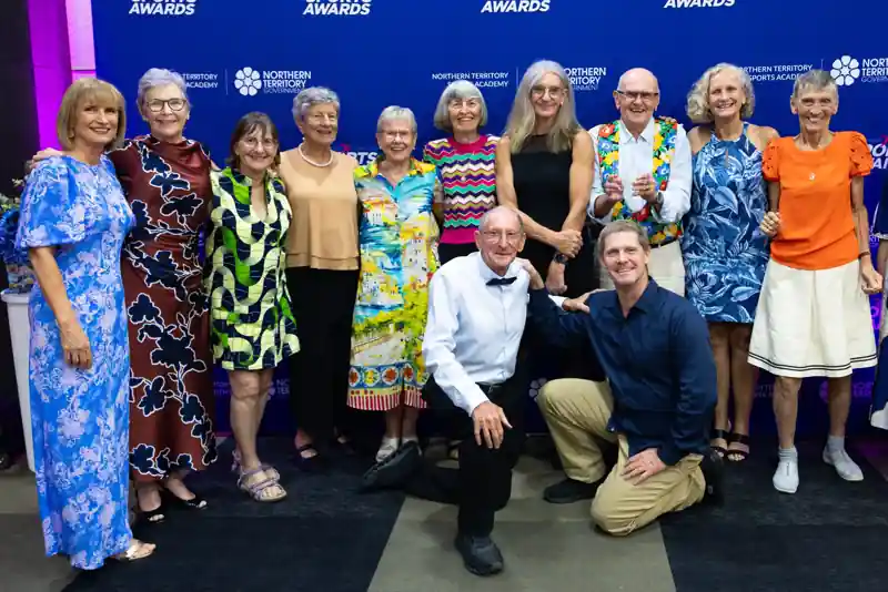 Group of NT sports award attendees in front of a blue 'sports awards' media wall