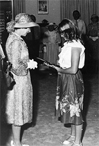 Peta Lynne Mann receiving the Royal Humane Society's Gold Medal for bravery from the Queen